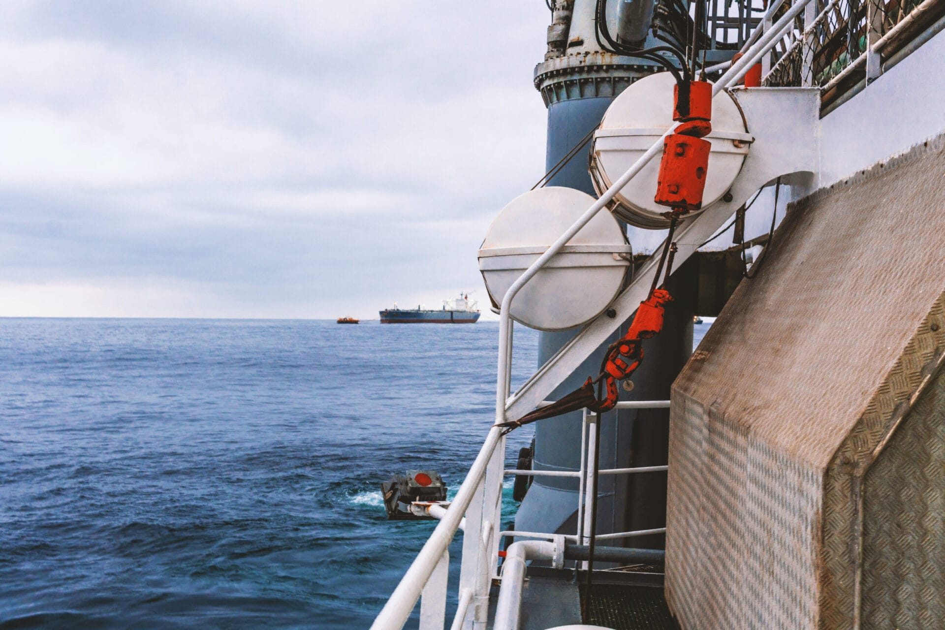 View of ocean from ship or vessel. LSA life saving equipment is on deck - liferafts , orange lifebouy ready for use in case of emergency