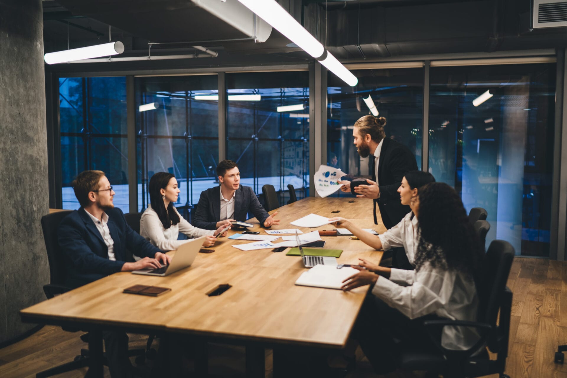 Coworkers discussing project in boardroom