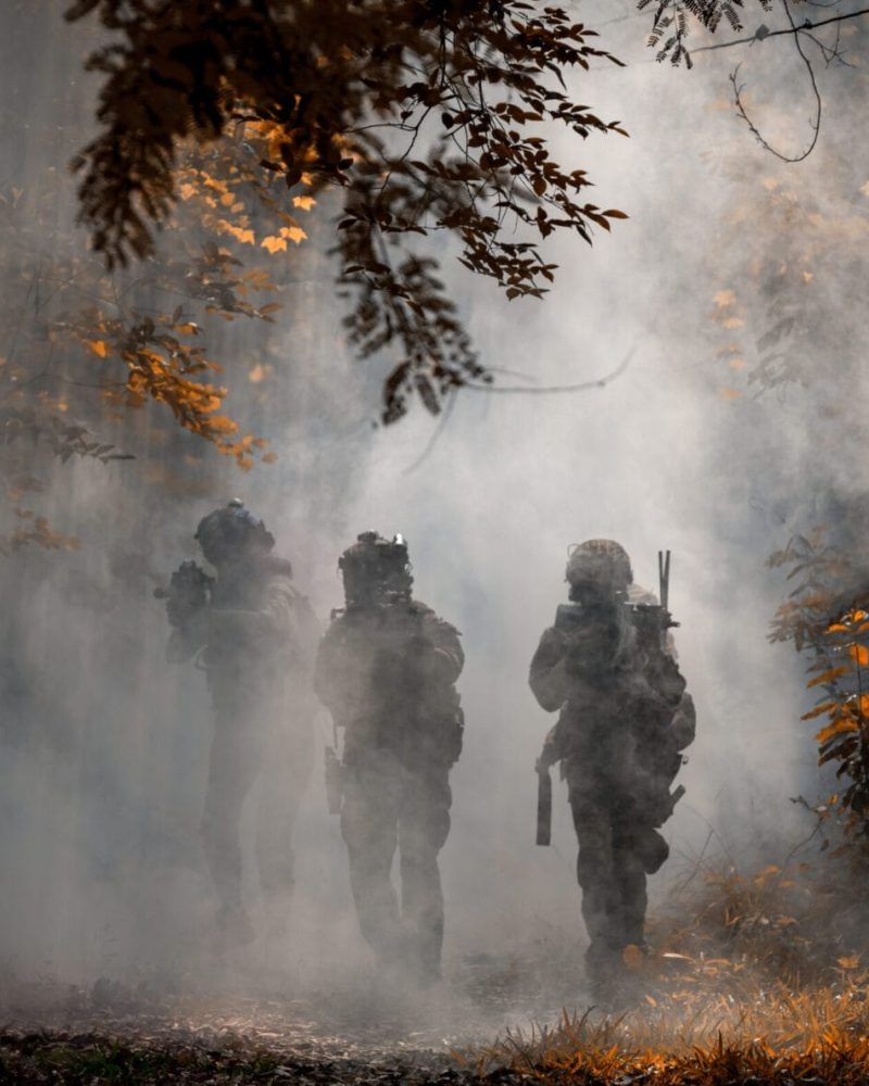 Soldier action with gun on hand holding to protect, survey aroun