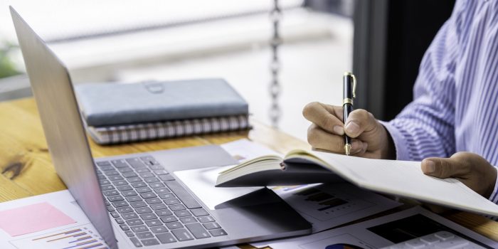 Analyzing Investment Charts. Auditor Checking Financial Report. Paperwork In The Office And Audit. A