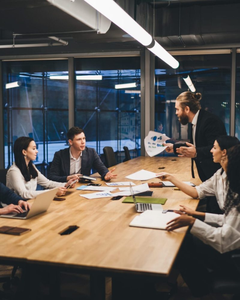 Coworkers discussing project in boardroom