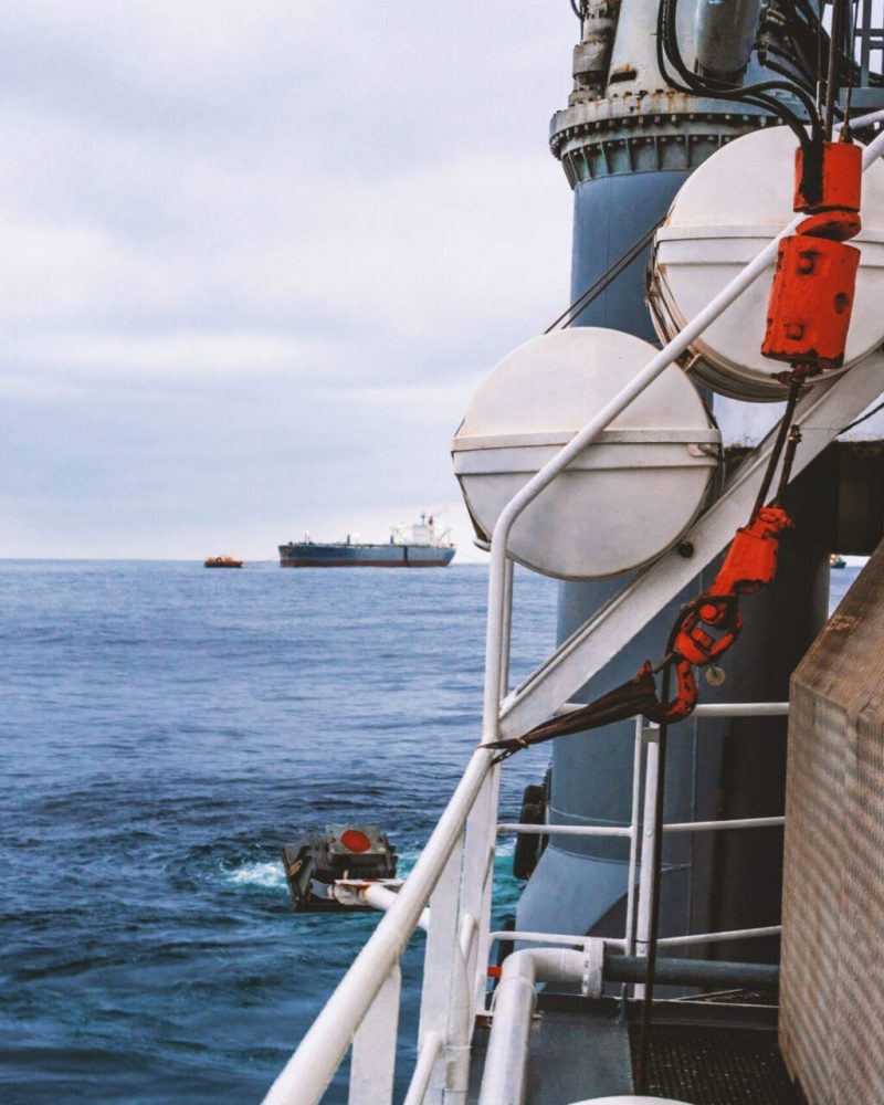 View of ocean from ship or vessel. LSA life saving equipment is on deck - liferafts , orange lifebouy ready for use in case of emergency